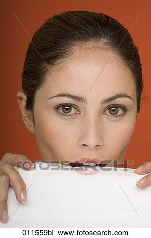 young woman blotting lipstick on tissue View Large Photo Image Stock Image - young woman blotting lipstick on tissue. Fotosearch