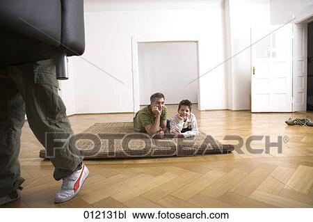 Stock Image - carpet, Yashoda, boy, artificial light, apartment, 10-12 years. Fotosearch