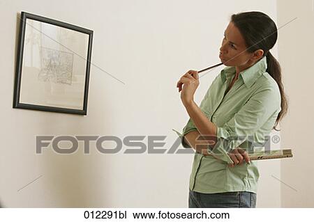 Stock Image - casual, checking, caucasian, artificial light. Fotosearch