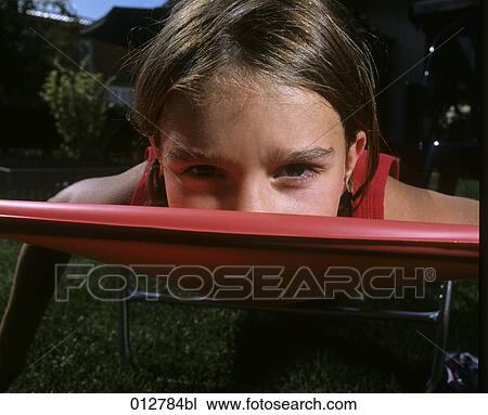 Stock Image - close-up of girl relaxing on sunlounger. Fotosearch