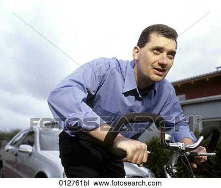close-up of man in business shirt riding bicycle View Large Photo Image Stock Image - close-up of man in business shirt riding bicycle. Fotosearch