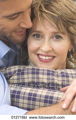 close-up of middle aged woman tenderly embraced by husband View Large Photo Image Stock Image - close-up of middle aged woman tenderly embraced by husband. Fotosearch