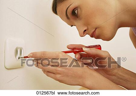 close-up of woman trying to repair socket with screwdriver View Large Photo Image Stock Image - close-up of woman trying to repair socket with screwdriver. Fotosearch