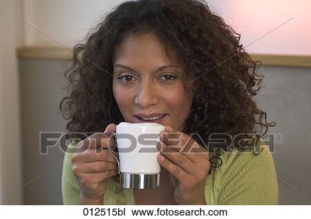 Stock Image - close-up of young african woman drinking coffee. Fotosearch