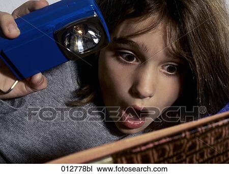 close-up of young girl with open mouth reading book View Large Photo Image Stock Image - close-up of young girl with open mouth reading book. Fotosearch