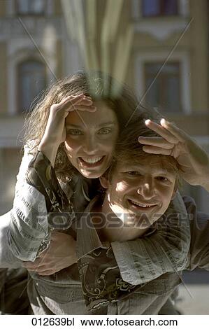 couple in close embrace looking at shop window View Large Photo Image Stock Image - couple in close embrace looking at shop window. Fotosearch