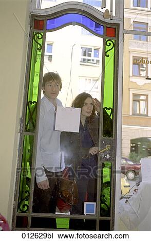 couple looking through door of closed shop View Large Photo Image Stock Image - couple looking through door of closed shop. Fotosearch