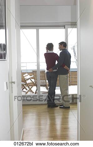 couple standing in embrace by the window View Large Photo Image Stock Image - couple standing in embrace by the window. Fotosearch
