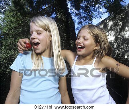 girl feeding her friend with cherry View Large Photo Image Stock Image - girl feeding her friend with cherry. Fotosearch