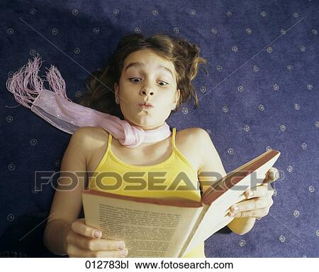 girl lying on the floor reading book View Large Photo Image Stock Image - girl lying on the floor reading book. Fotosearch