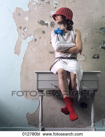girl with red cap sitting on chest of drawers View Large Photo Image Stock Image - girl with red cap sitting on chest of drawers. Fotosearch
