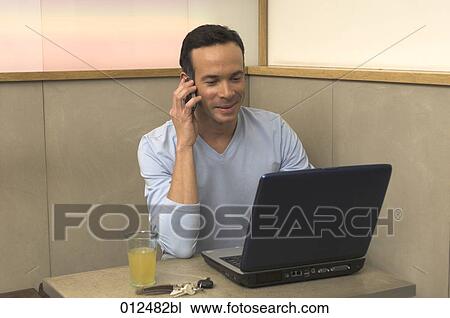 happy looking man listening to his cellphone in restaurant View Large Photo Image Stock Image - happy looking man listening to his cellphone in restaurant. Fotosearch