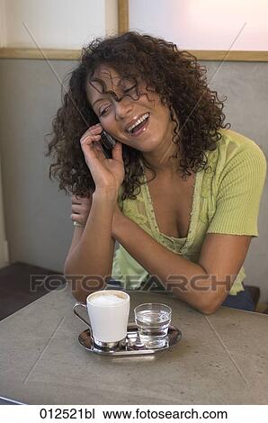 happy looking young woman talking on mobile in cafe View Large Photo Image Stock Image - happy looking young woman talking on mobile in cafe. Fotosearch