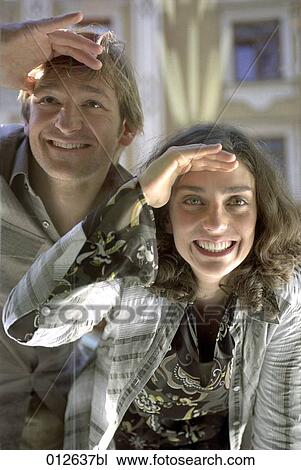 happy young couple peeping through shop window View Large Photo Image Stock Image - happy young couple peeping through shop window. Fotosearch