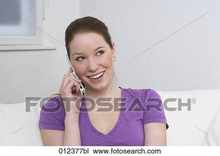 Stock Image - happy young woman with cellular phone. Fotosearch