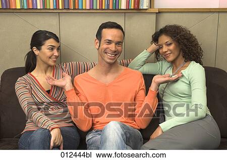 man in orange sweater laughing with his friends View Large Photo Image Stock Image - man in orange sweater laughing with his friends. Fotosearch