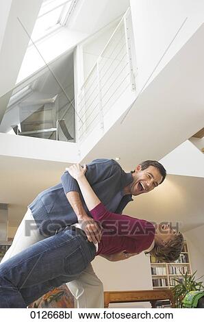 mature couple frolicking in their home View Large Photo Image Stock Image - mature couple frolicking in their home. Fotosearch