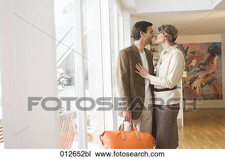 mature couple kissing near window of their apartment View Large Photo Image Stock Image - mature couple kissing near window of their apartment. Fotosearch
