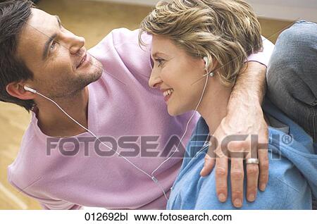 mature couple listening to music with earphones View Large Photo Image Stock Image - mature couple listening to music with earphones. Fotosearch
