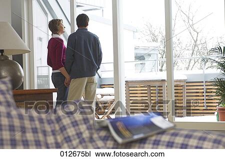 mature couple looking at snowy balcony View Large Photo Image Stock Image - mature couple looking at snowy balcony. Fotosearch