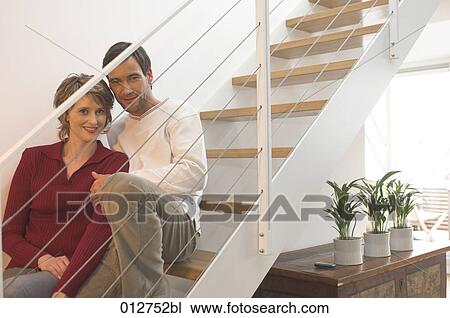 mature couple looking through railing of stairs in their home View Large Photo Image Stock Image - mature couple looking through railing of stairs in their home. Fotosearch