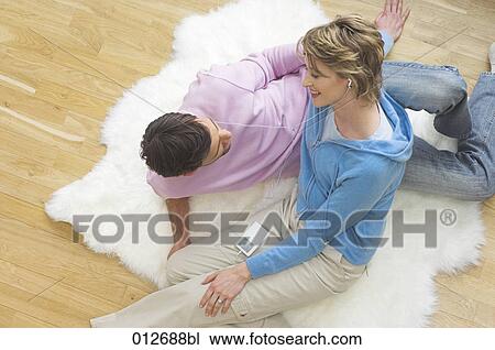 mature couple lying on fleece sharing an ipod View Large Photo Image Stock Image - mature couple lying on fleece sharing an ipod. Fotosearch