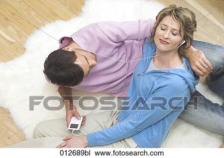 mature couple relaxing on floor and listening to music View Large Photo Image Stock Image - mature couple relaxing on floor and listening to music. Fotosearch
