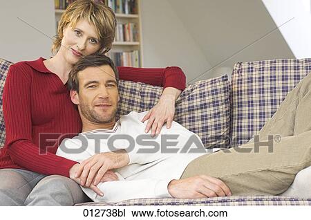 mature couple sitting on couch man holding woman´s hand View Large Photo Image Stock Image - mature couple sitting on couch man holding woman´s hand. Fotosearch