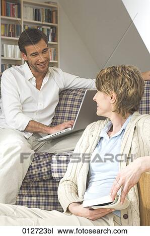 mature couple sitting together and smiling at each other View Large Photo Image Stock Image - mature couple sitting together and smiling at each other. Fotosearch
