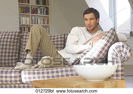 mature man lying comfortably on sofa View Large Photo Image Stock Image - mature man lying comfortably on sofa. Fotosearch