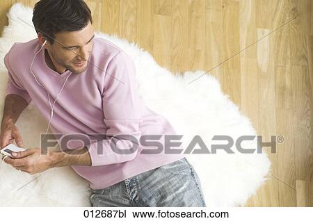 mature man lying on fleece listening to his ipod View Large Photo Image Stock Image - mature man lying on fleece listening to his ipod. Fotosearch
