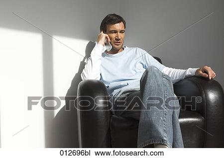 mature man sitting in leather chair talking on cell phone View Large Photo Image Stock Image - mature man sitting in leather chair talking on cell phone. Fotosearch
