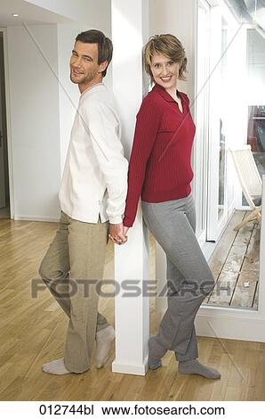 mature standing back to back and holding hands View Large Photo Image Stock Image - mature standing back to back and holding hands. Fotosearch