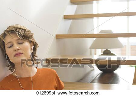 mature woman with closed enjoying some music View Large Photo Image Stock Image - mature woman with closed enjoying some music. Fotosearch