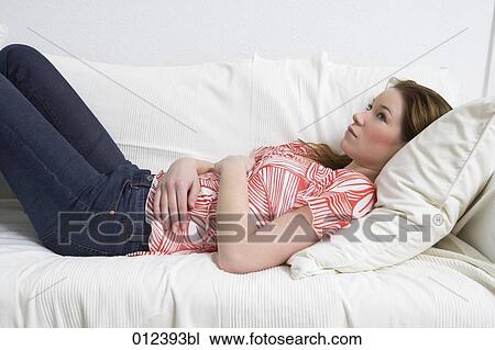 melancholic looking young woman lying on couch View Large Photo Image Stock Image - melancholic looking young woman lying on couch. Fotosearch