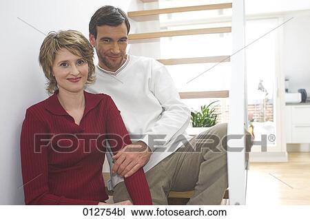 middle aged couple sitting on stairs View Large Photo Image Stock Image - middle aged couple sitting on stairs. Fotosearch