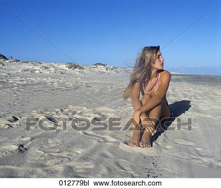 portrait of blonde woman sitting on sandy beach View Large Photo Image Stock Image - portrait of blonde woman sitting on sandy beach. Fotosearch