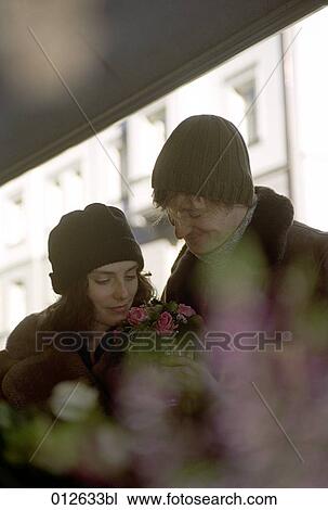 portrait of couple buying flowers in winter View Large Photo Image Stock Image - portrait of couple buying flowers in winter. Fotosearch