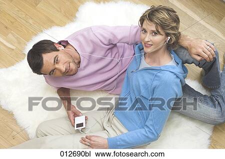 portrait of mature couple lying on floor and listening to music View Large Photo Image Stock Image - portrait of mature couple lying on floor and listening to music. Fotosearch