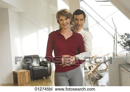 portrait of mature couple standing together in their living room View Large Photo Image Stock Image - portrait of mature couple standing together in their living room. Fotosearch