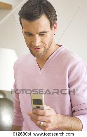 portrait of mature man looking at display of mobile phone View Large Photo Image Stock Image - portrait of mature man looking at display of mobile phone. Fotosearch