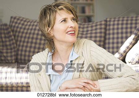 portrait of mature woman sitting in living room View Large Photo Image Stock Image - portrait of mature woman sitting in living room. Fotosearch