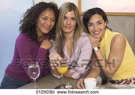 portrait of multiethnic group of young women in cafe View Large Photo Image Stock Image - portrait of multiethnic group of young women in cafe. Fotosearch