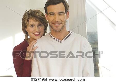 Stock Image - portrait of smiling middle aged couple. Fotosearch