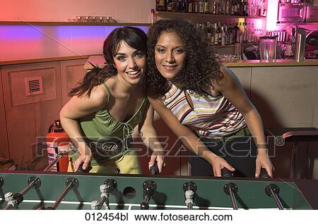 portrait of two female friends playing tabletop football View Large Photo Image Stock Image - portrait of two female friends playing tabletop football. Fotosearch
