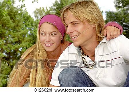 portrait of young couple sitting in park View Large Photo Image Stock Image - portrait of young couple sitting in park. Fotosearch