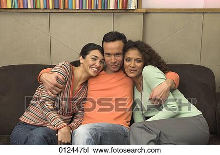 portrait of young man embracing two female friends View Large Photo Image Stock Image - portrait of young man embracing two female friends. Fotosearch