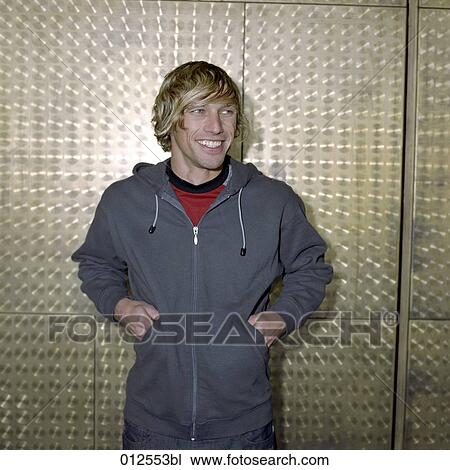 portrait of young man standing in front of metal wall View Large Photo Image Stock Image - portrait of young man standing in front of metal wall. Fotosearch