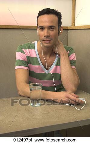 portrait of young man with earphones and ipod View Large Photo Image Stock Image - portrait of young man with earphones and ipod. Fotosearch