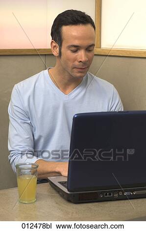 portrait of young man working with notebook in restaurant View Large Photo Image Stock Image - portrait of young man working with notebook in restaurant. Fotosearch